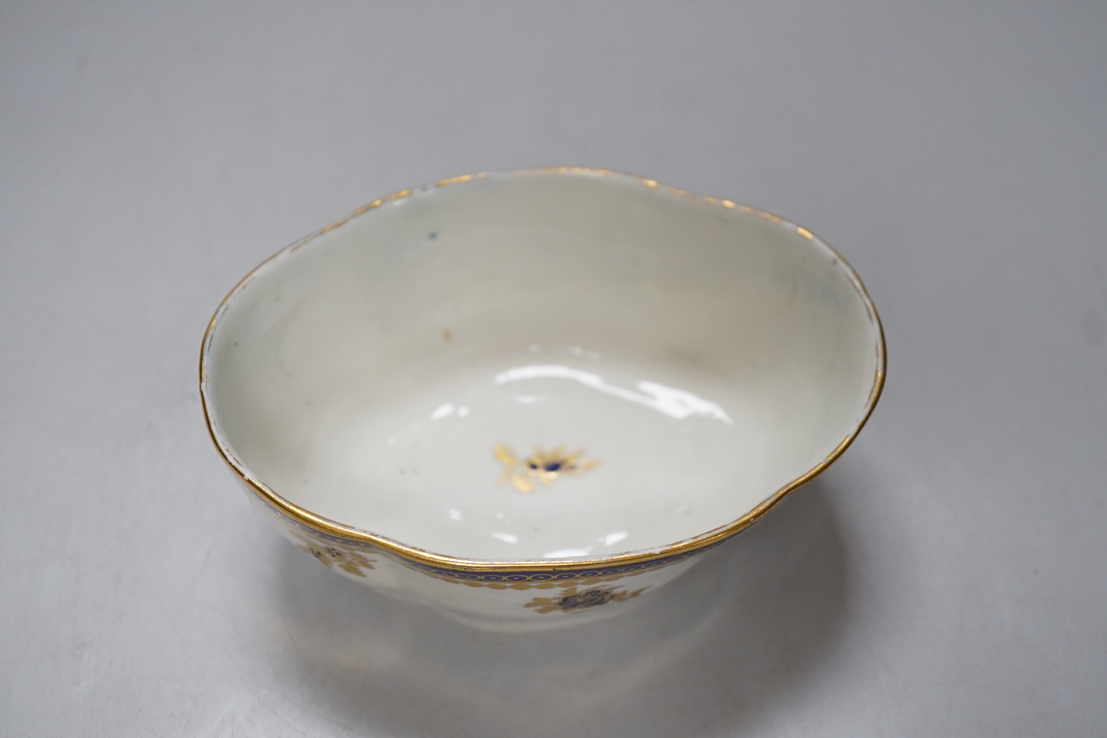 An 18th century Caughley tureen cover and stand with blue and gilt decoration, stand mis-fired to border, S mark to stand and base. 15cm wide